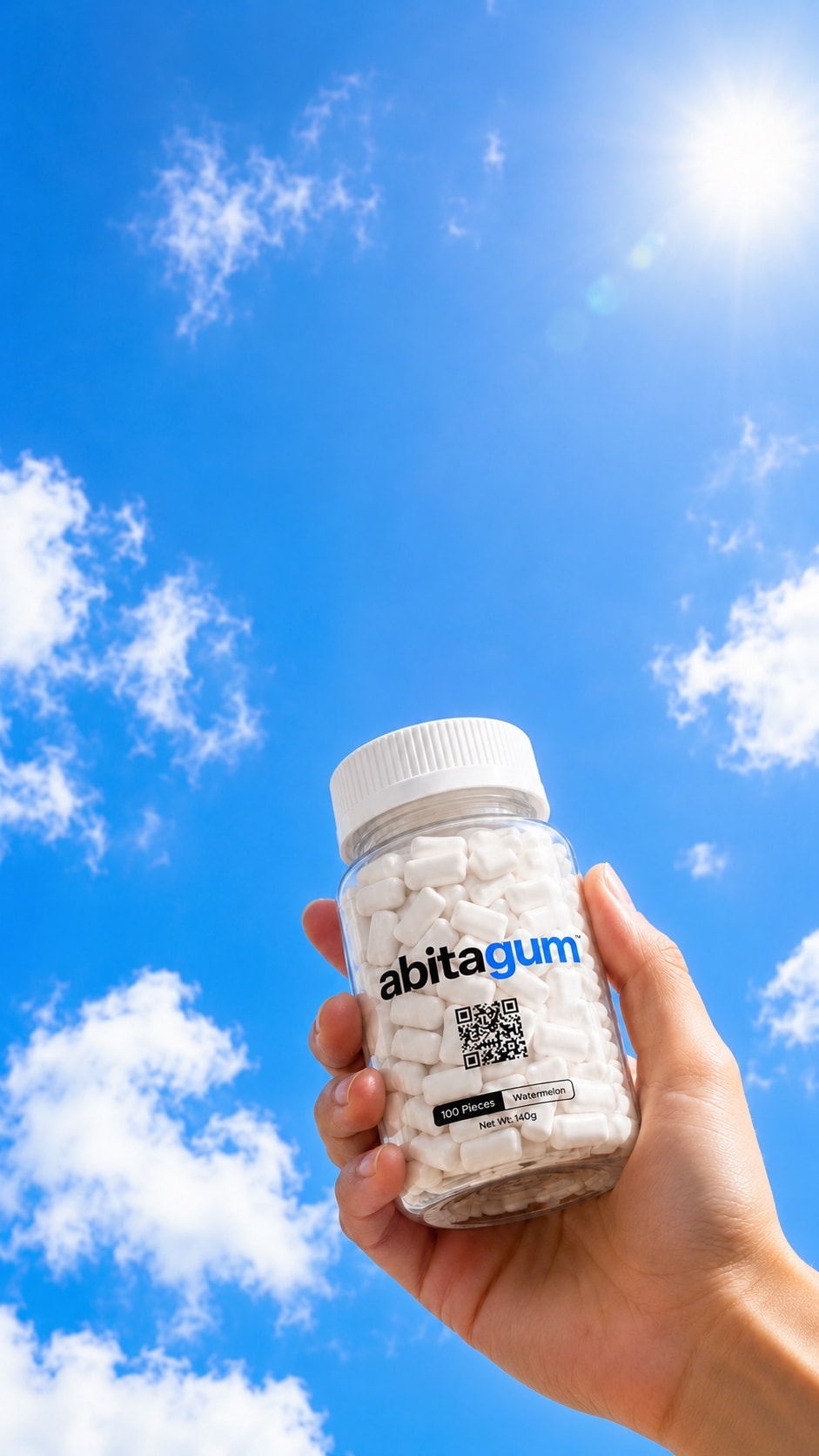 Abitagum Focus Gum bottle held up to a bright blue sky